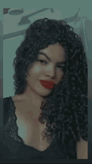 a close up of a woman 's face with red lipstick smiling