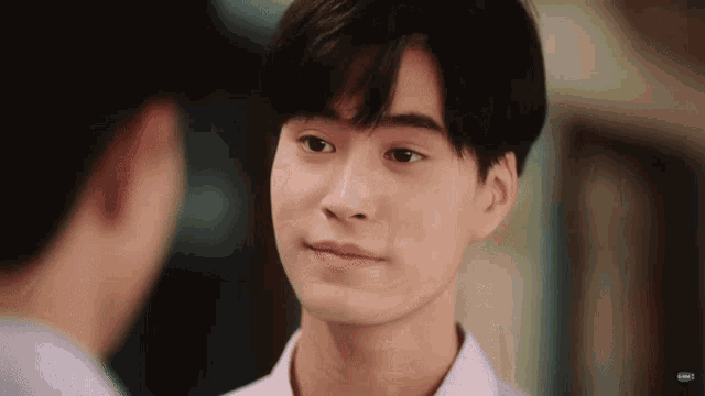 a close up of a young man 's face looking at another man