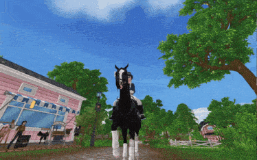 a woman riding a black horse in front of a pink house