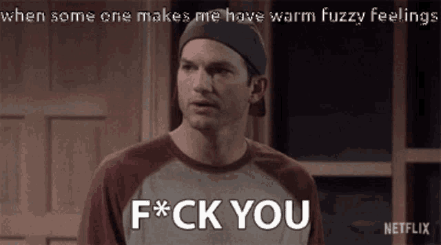 a man wearing a baseball cap and a t-shirt that says f * ck you