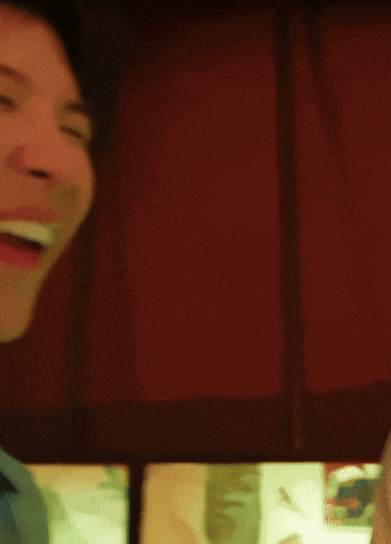 a close up of a man 's face with his mouth open and his eyes closed .