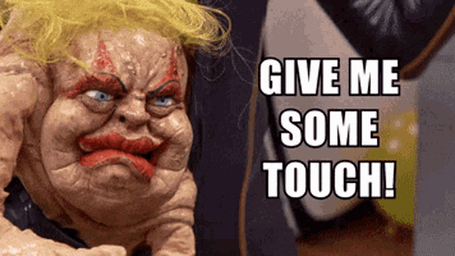 a puppet says give me some touch in front of a yellow balloon