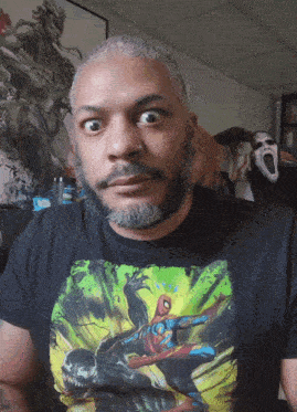 a man wearing a t-shirt with a spider-man and venom on it