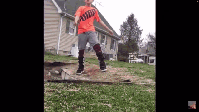 a young boy wearing an orange shirt that says " jump "