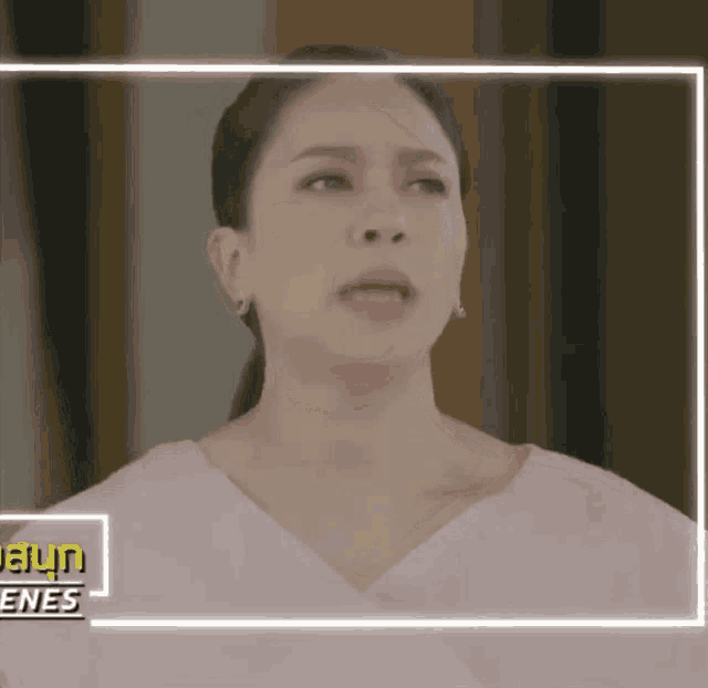 a close up of a woman 's face in a frame with the word scenes on the bottom .