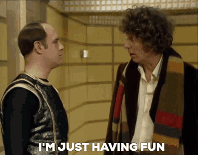 two men standing next to each other with the words i 'm just having fun