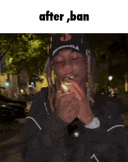 a man with dreadlocks is lighting a cigarette with the words after ban above him