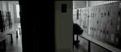 a row of lockers are lined up in a dark room .