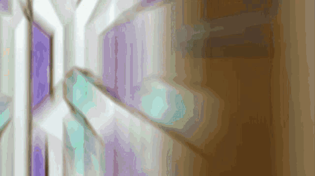 a stained glass window with a purple and blue border