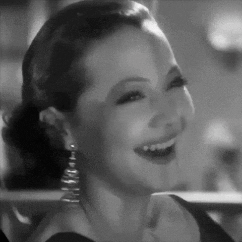 a woman is smiling in a black and white photo .