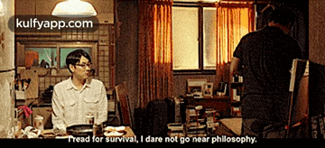 a man sitting at a table talking to another man with the words " i read for survival " on the top