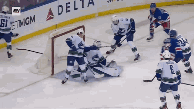 a hockey game is being played in front of a delta airlines banner