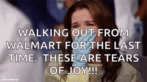 a woman is crying while walking out from walmart for the last time . these are tears of joy .