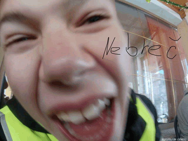 a close up of a man 's face with the word kobec written on his face