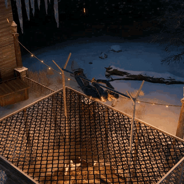 a person is hanging from a rope in a hammock in the snow