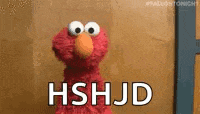 elmo from sesame street is standing in front of a wall and saying hshjd .