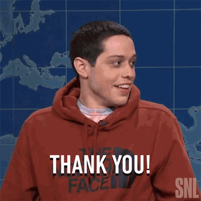 a man wearing a red north face hoodie is saying thank you
