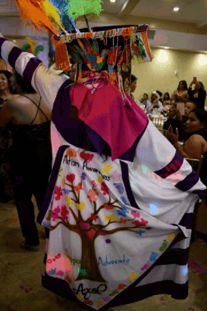 a person wearing a colorful costume that says " autism awareness "