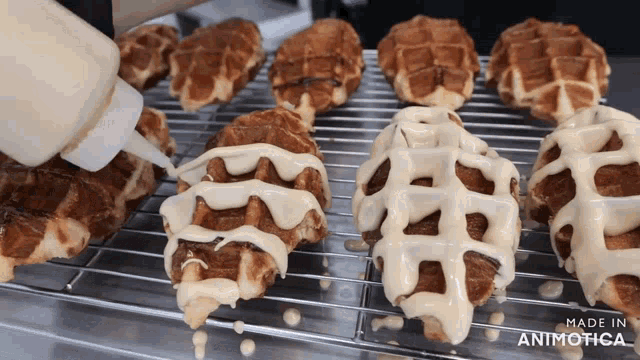 a bunch of waffles are sitting on a cooling rack and the words made in animotica are on the bottom right