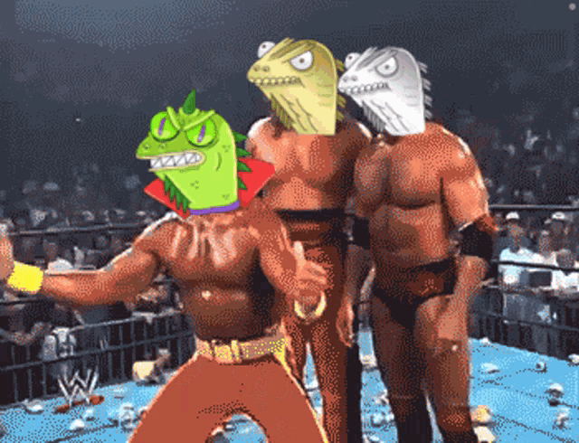 a group of wrestlers are standing in a ring and one has a lizard head on his head