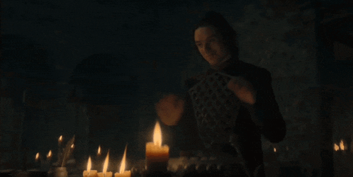 a man stands in front of a table with candles lit up