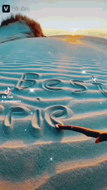 a person is drawing the word best friend in the sand
