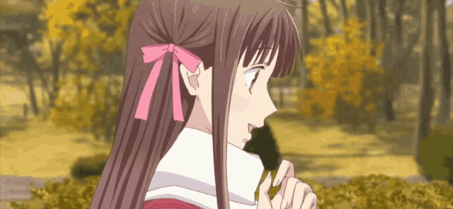 a girl with long brown hair and a pink bow on her hair