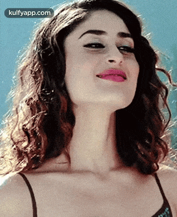 a close up of a woman 's face with her mouth open and her tongue out .