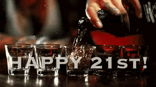 a person is pouring alcohol into a row of shot glasses with the words happy 21st written on the bottom .