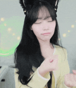 a girl wearing a cat ear headband is making a face