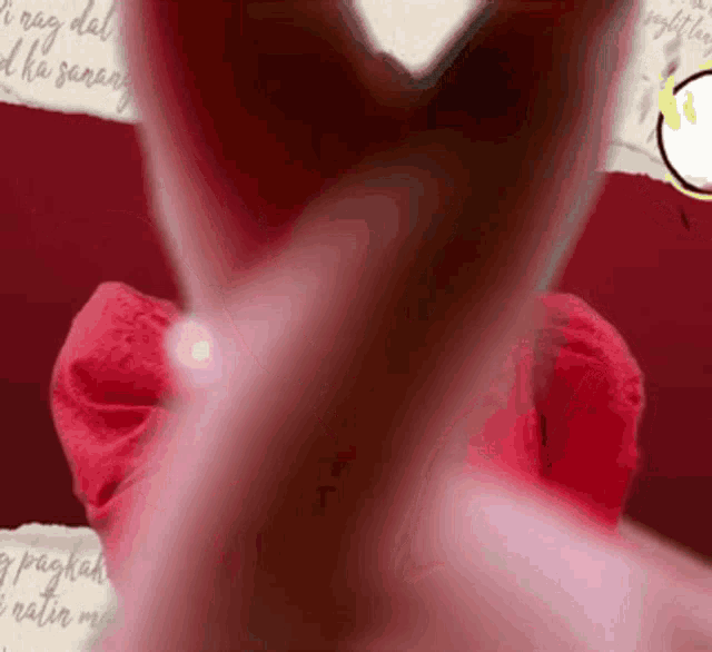 a close up of a person making a heart shape