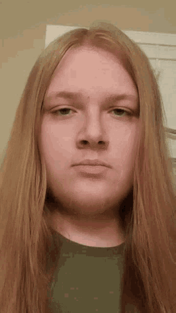 a young man with long blonde hair and a beard