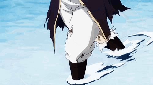 a person is standing in the water with their feet in the water and their pants ripped .