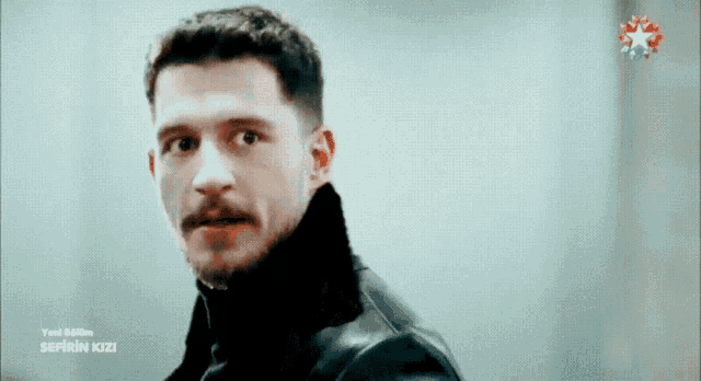 a man with a mustache is on a tv screen that says sefirin kizi on it