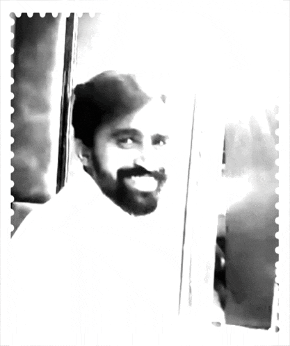 a black and white photo of a man with a beard and red hearts