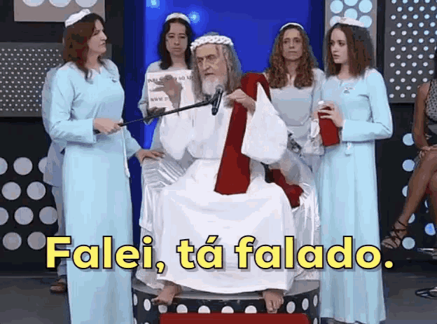a man in a white robe is sitting on a throne surrounded by women with the words falei ta falado in yellow letters