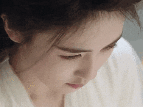 a close up of a woman 's face with her eyes closed .