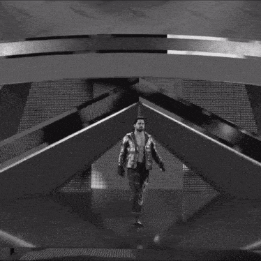 a black and white photo of a man in a silver jacket walking down stairs