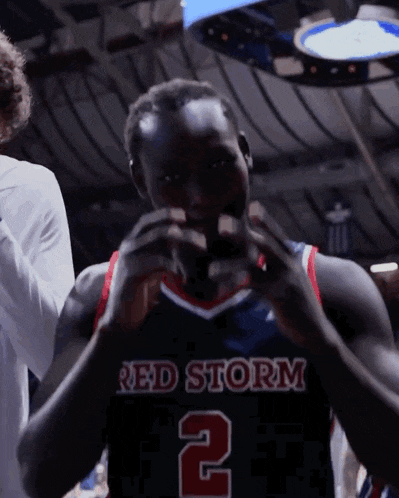 a basketball player wearing a red storm jersey with the number 2 on it