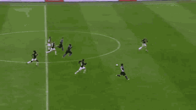 a group of soccer players are playing on a field and one player has the number 15 on his jersey
