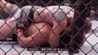 a man is laying on the ground in a cage with the number 30 on his arm
