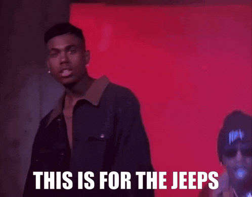 a man stands in front of a red wall with the words this is for the jeeps