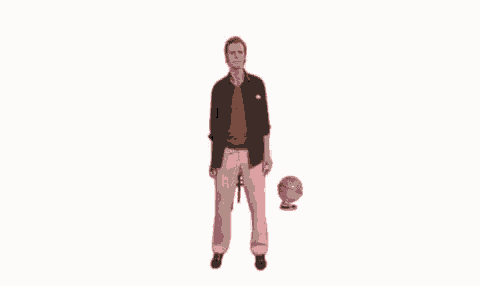 a man in pink pants is standing next to a globe and looking at it .
