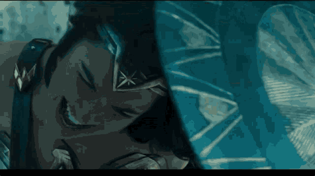 a close up of a woman in a wonder woman costume laughing while laying on a bed .