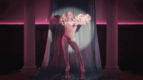 a drag queen named drag chuchi is holding a wand