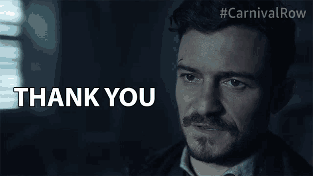 a close up of a man 's face with the words thank you behind him