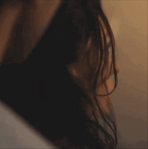 a close up of a woman 's face with her eyes closed