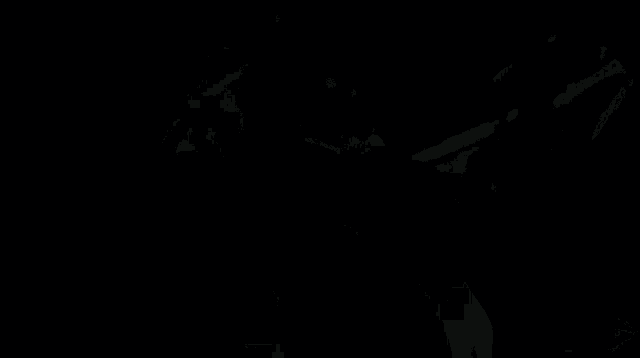 a close up of a joker 's face with a dark background