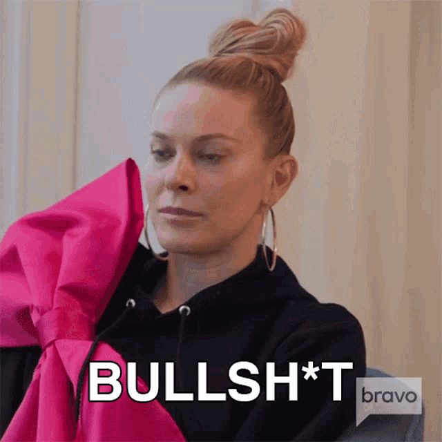 a woman is wearing a black hoodie with a pink bow and the word bullshit on the bottom