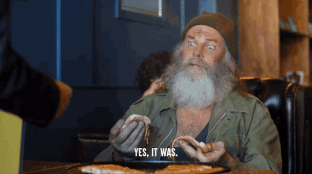 a man with a beard says yes it was while eating pizza